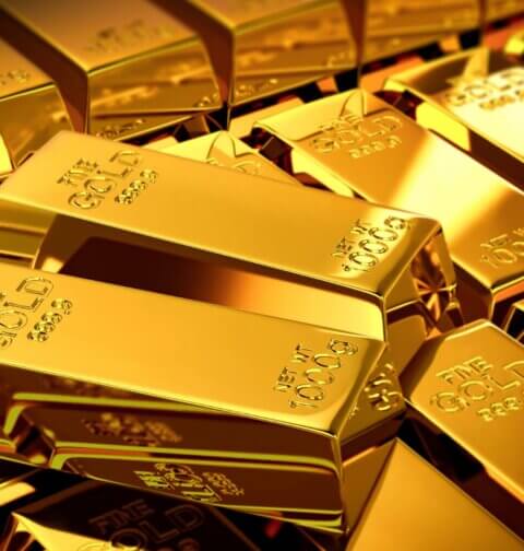 Stack of 1000g fine gold bars – gold price forecast and 50-year outlook on gold investment, AI impact and global economic scenarios