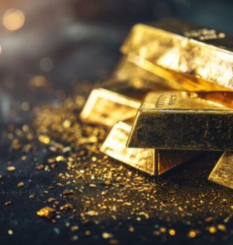Stapel Goldbarren auf dunklem Hintergrund – physisches Goldbarren symbolisiert Werterhaltung, Goldinvestition und den zeitlosen Wertspeicher durch die Geschichte